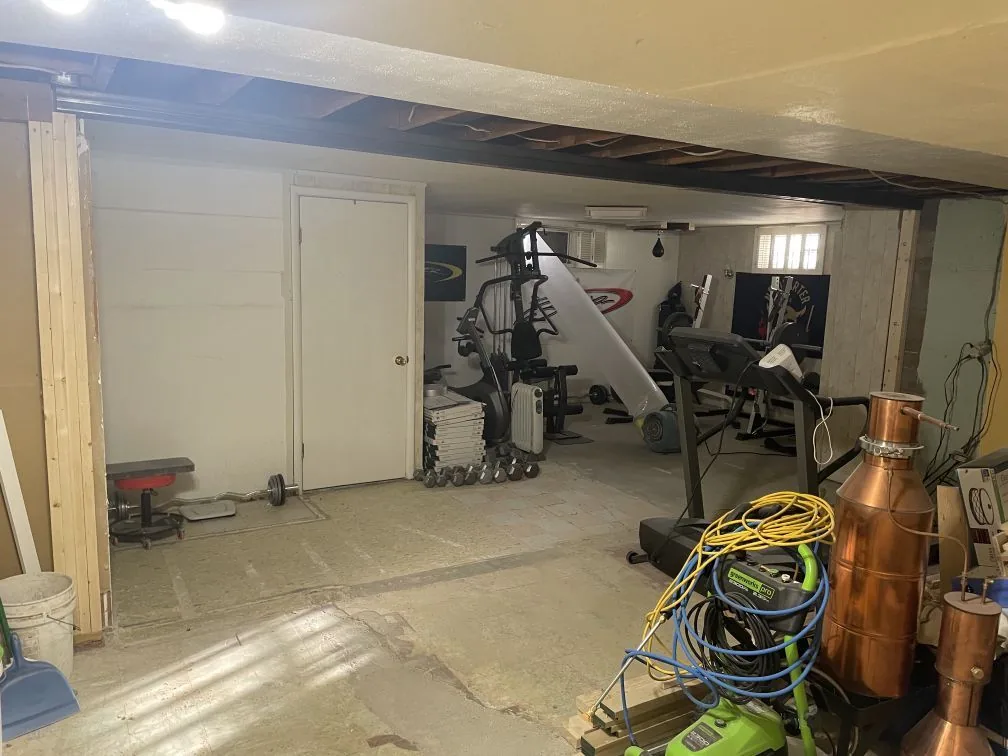 Load-Bearing Wall Removal · Bismarck, ND — basement wall removed, new structural header carrying the load across the open floor plan.