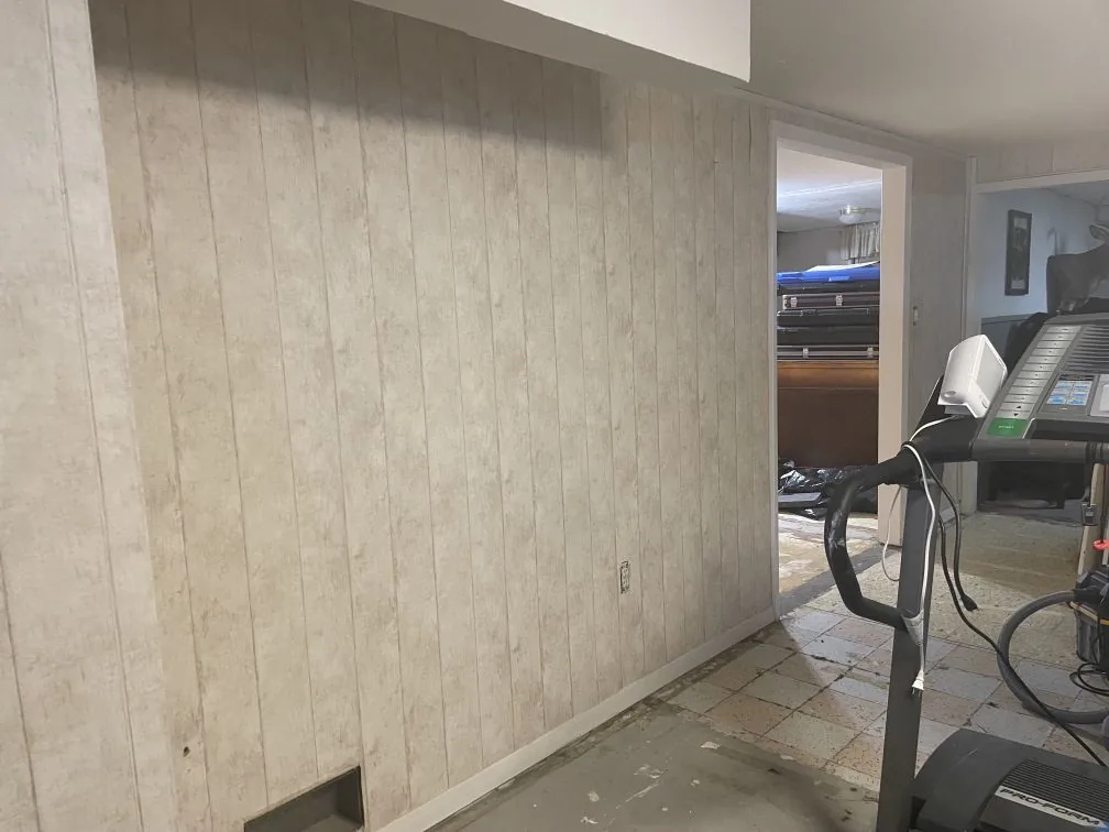Load-Bearing Wall Removal · Bismarck, ND — before photo of the original paneled load-bearing wall.