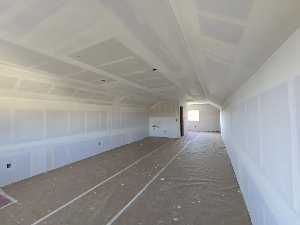 The Ranch Remodel — vaulted bonus room above the shop at the drywall stage, ceiling hung and taped.