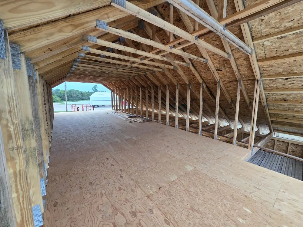 The Ranch Remodel — sheathed bonus room floor with the full vaulted truss ceiling overhead.