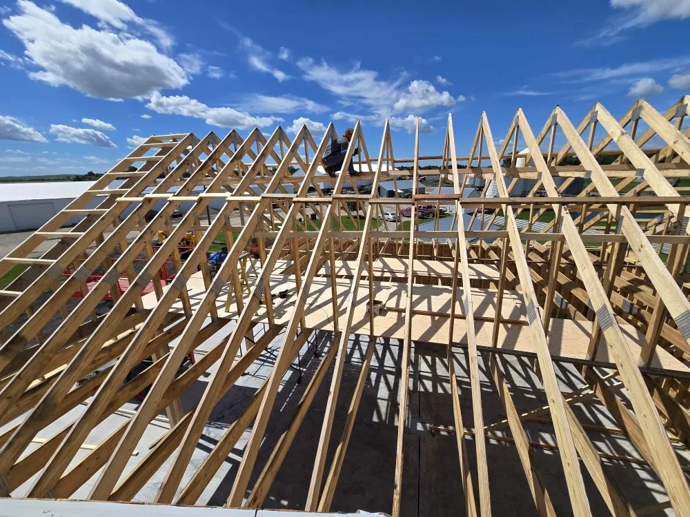 The Ranch Remodel — framing the roof trusses against a big North Dakota sky.