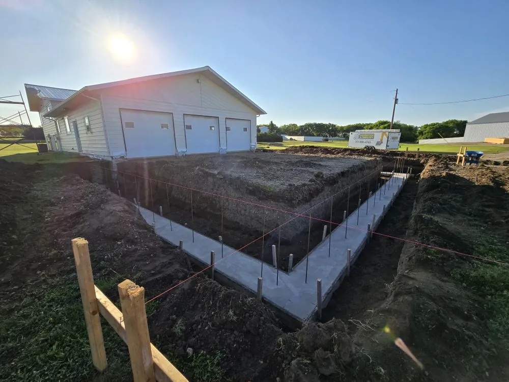 Footings set and ready for the Ranch Remodel addition — original 1988 structure on the left.