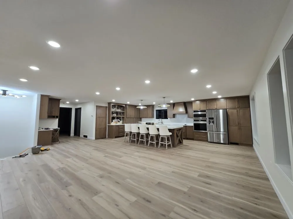 Open-concept kitchen with custom maple cabinets, large island, and stone countertops — the Ranch Remodel.